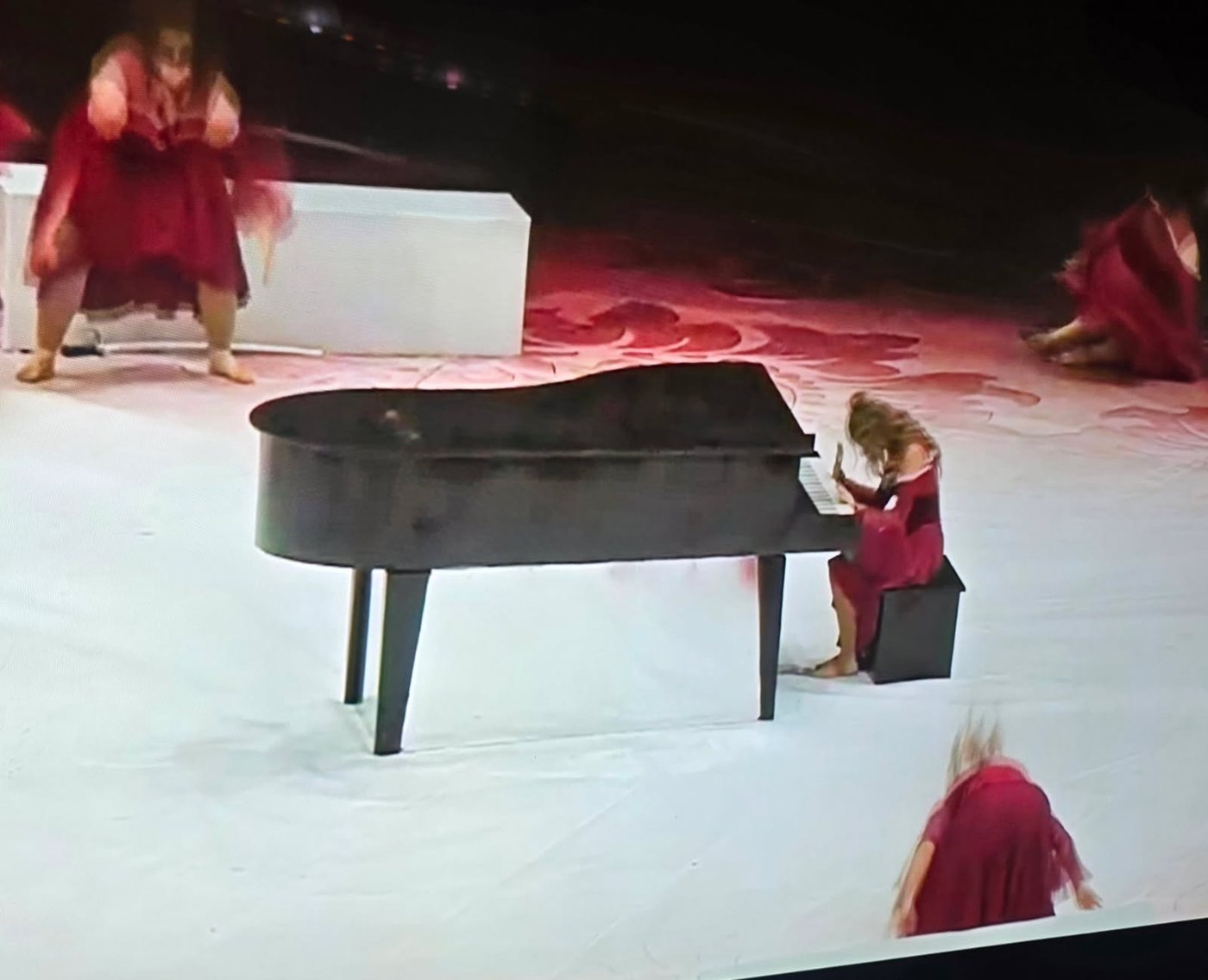 Performers dancing with the grand piano prop during MCWG performance