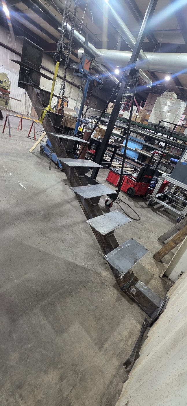 Steel staircase stringer fabricated in the shop