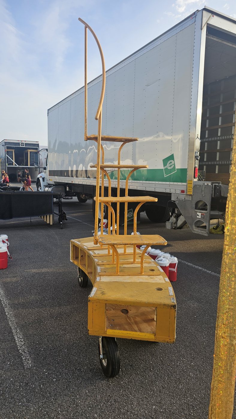 Soloist steps prop staged for load-in next to equipment trailer