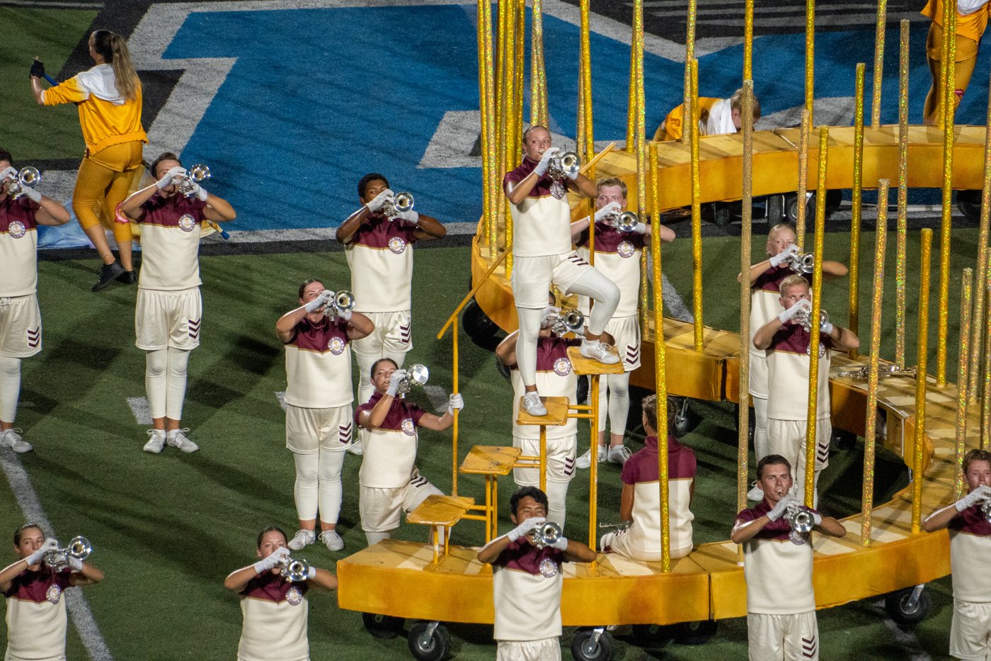 Cadets brass line performing around the curved soloist steps prop