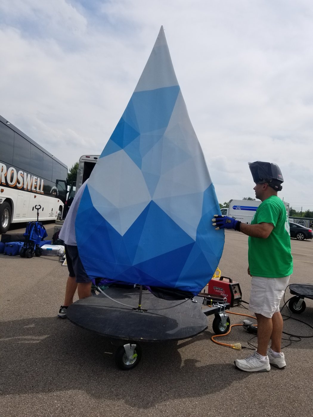 Fabric-covered rotating water drop prop on a 3-legged stand