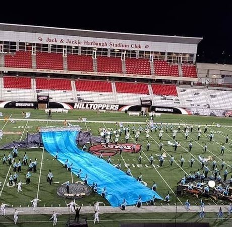 150 foot blue waterfall curtain and scaffolding platform on the field at MCMB Welcome to the Jungle