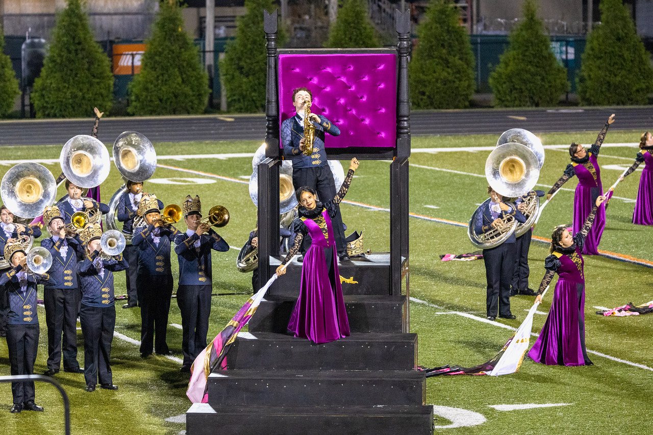 Performers on the oversized throne prop with integrated steps at MCMB Queen of Kings